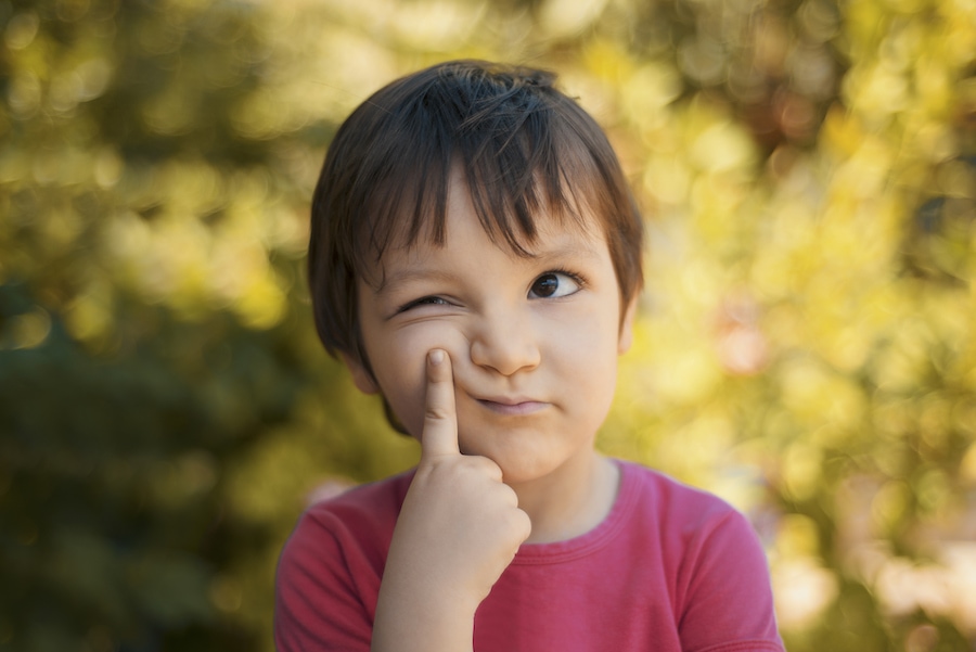 Little boy looking confused wondering if HVAC preventative maintenance is worth it for his heating and cooling system