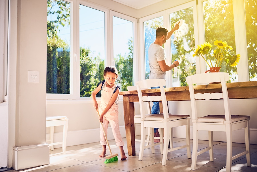 Dad and daughter cleaning home to show how environmental issues can affect your AC system.